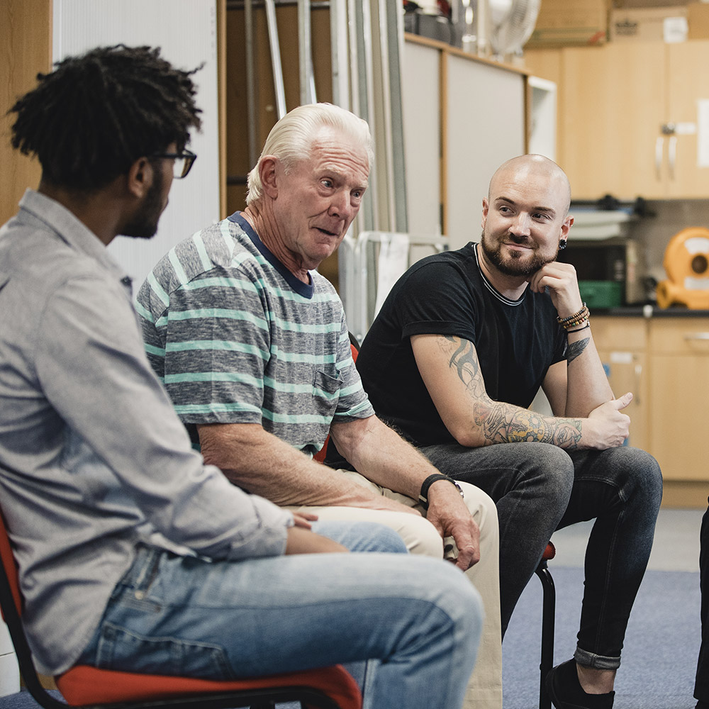 A photo of group of men having a discussion